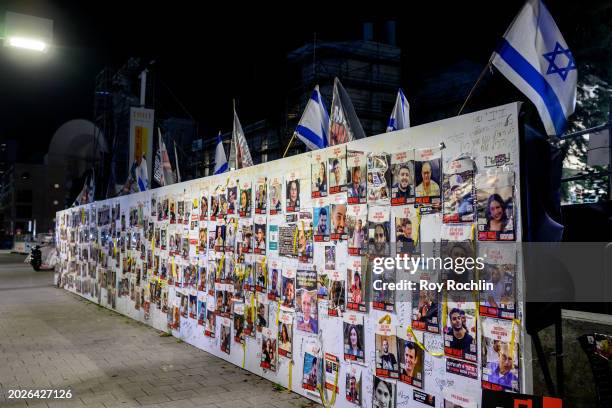 Posters of the Hamas hostages are posted on a wall at "Hostages Square" outside the HaKirya base, which serves as IDF headquarters, where family...