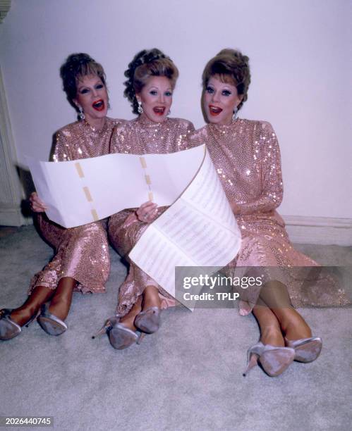 Christine McGuire , Dorothy McGuire and Phyllis McGuire , of the American popular music trio The McGuire Sisters, holding sheet music and wearing...