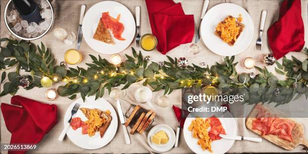 food, breakfast and table with christmas decoration for a festive family celebration feast. event, juice and high angle of gourmet xmas brunch with salmon, eggs and bread on plate for holiday party. - banquet stock pictures, royalty-free photos & images
