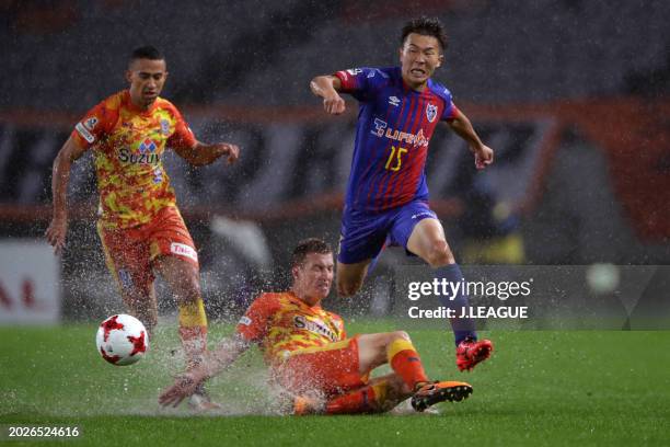 Kensuke Nagai of FC Tokyo is tackled by Mitchell Duke of Shimizu S-Pulse during the J.League J1 match between FC Tokyo and Shimizu S-Pulse at...