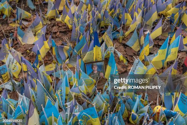 This photograph taken on February 24 shows flags bearing symbols and colours of Ukraine set to commemorate fallen Ukrainian army soldiers at...