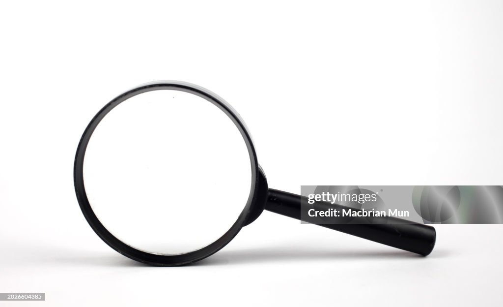 Magnifying glass over white background
