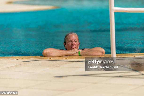 mature woman relaxing at a swimming pool - guerrero stock pictures, royalty-free photos & images