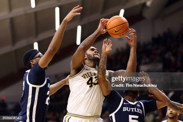 Eric Dixon of the Villanova Wildcats challenges for a rebound with Andre Screen and Posh Alexander of the Butler Bulldogs during the second half at...