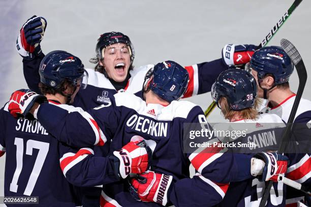 Alex Ovechkin of the Washington Capitals celebrates with teammates after scoring a goal against the New Jersey Devils during the third period at...