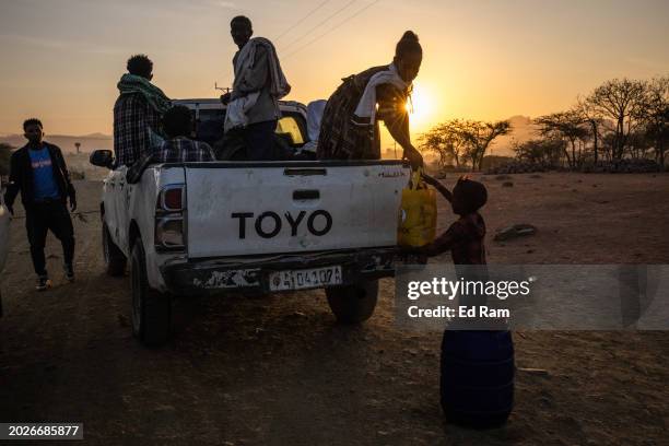 People unload belongings from a pickup truck at a checkpoint at dawn on the outskirts of Yechila town in the Yechila district on February 19, 2024 in...