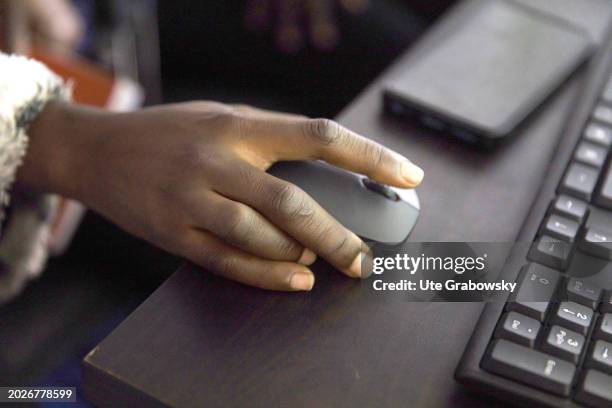Hand on a computer mouse in Africa, on February 06, 2024 in Jos, Nigeria.