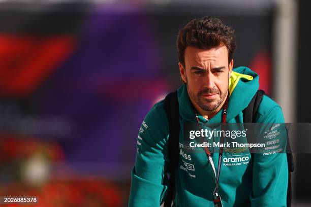 Fernando Alonso of Spain and Aston Martin F1 Team looks on in the Paddock during day one of F1 Testing at Bahrain International Circuit on February...