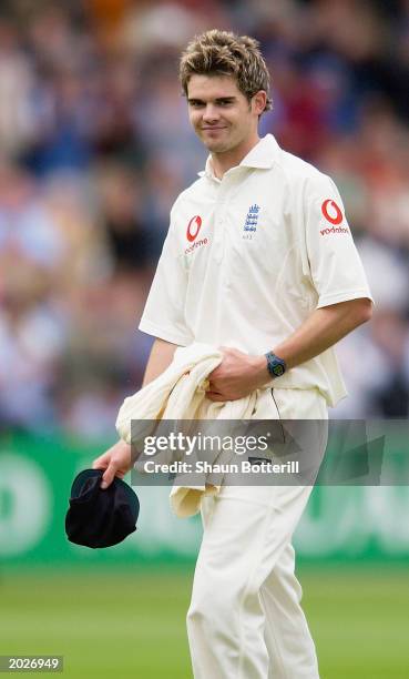 James Anderson of England is all smiles as he walks off having taken five wickets during Zimbabwe's first innings on the third day of the first...