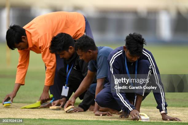 Groundstaff prepare the pitch during a nets session at JSCA International Stadium Complex on February 21, 2024 in Ranchi, India.