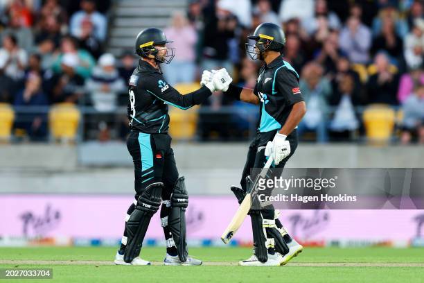 Devon Conway celebrates his half century with Rachin Ravindra during game one of the Men's T20 International series between New Zealand and Australia...