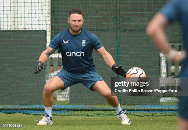 Brendon McCullum of England attempts to stop a football during the England Net Session at JSCA International Stadium Complex on February 21, 2024 in...