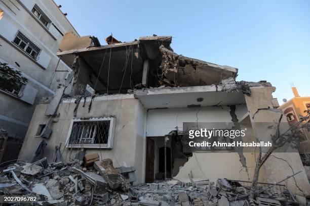 Debris is seen around a damaged building following Israeli air strikes on February 21, 2024 in Rafah, Gaza. Strikes have intensified as Israel...