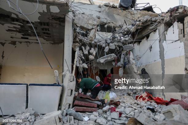 People inspect damage to their homes following Israeli air strikes on February 21, 2024 in Rafah, Gaza. Strikes have intensified as Israel reiterated...