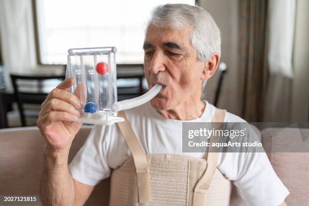 breathing exercises with spirometer at home - orthopedic corset stock pictures, royalty-free photos & images