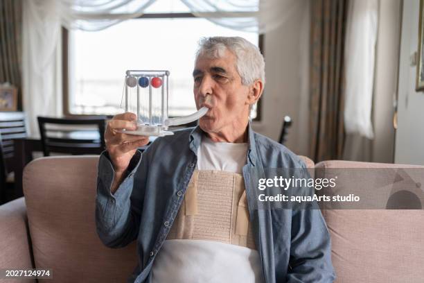 breathing exercises with spirometer at home - heart bypass stock pictures, royalty-free photos & images