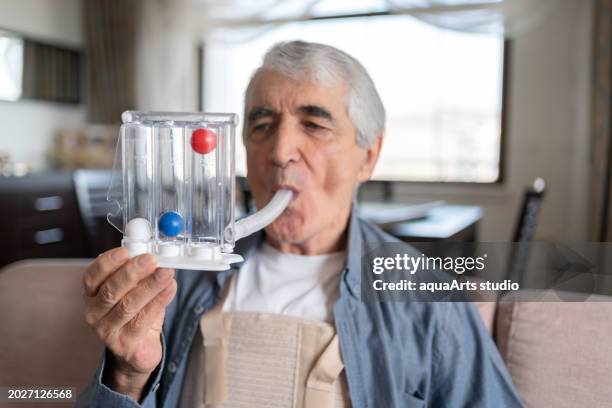 breathing exercises with spirometer at home - orthopedic corset stock pictures, royalty-free photos & images