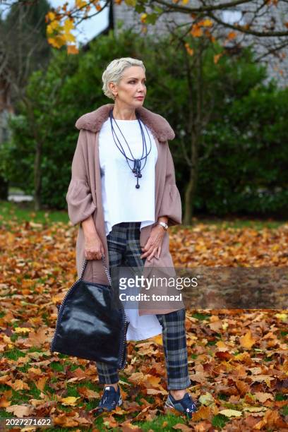 fashionable mature woman autumn portrait - woman short blond hair stock pictures, royalty-free photos & images