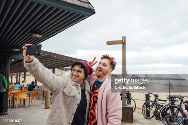 selfies together at the beach - tynemouth stock pictures, royalty-free photos & images