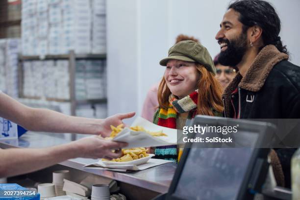 ordering fish and chips - multi coloured glove stock pictures, royalty-free photos & images