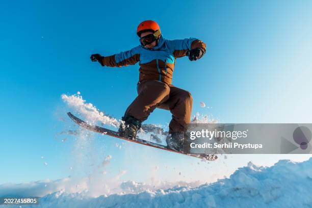 man jumping with a snowboard - nordic skiing event stock pictures, royalty-free photos & images