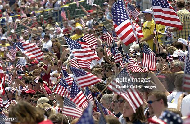 Supporters wave U.S. Flags as they attend the Rally for America event at Marshall University stadium May 24, 2003 in Huntington, West Virginia. The...