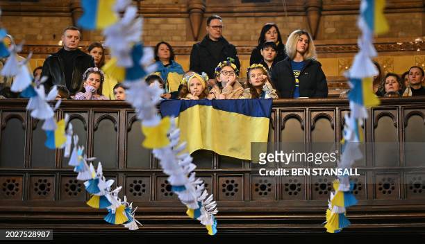 Attendees are pictured through some 528 paper angels, said to represent the number of children killed in Ukraine sice the beginning of the invasion...