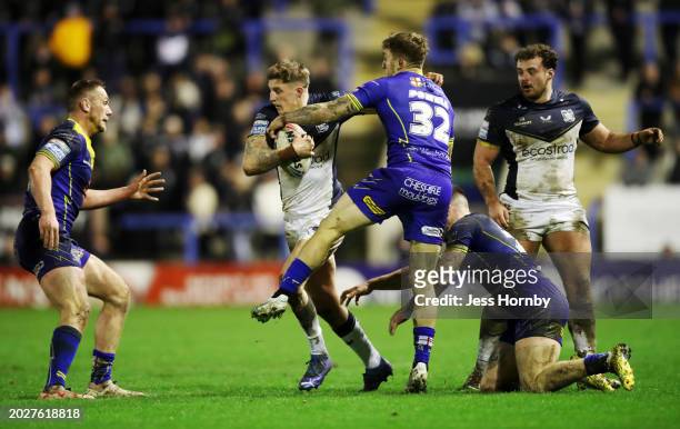 Liam Sutcliffe of Hull FC is tackled by Sam Powell of Warrington Wolves during the Betfred Super League match between Warrington Wolves and Hull FC...