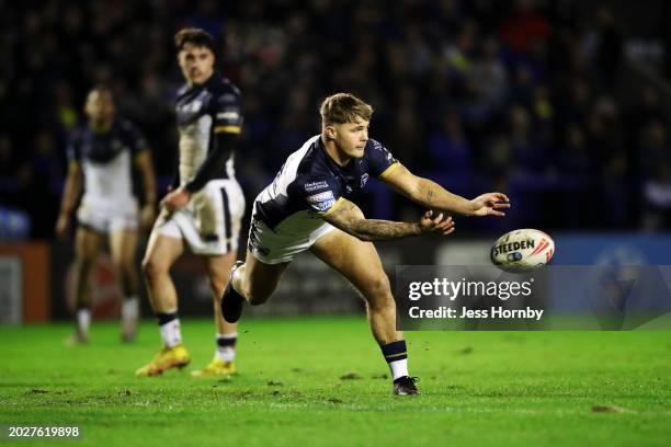 Denive Balmforth of Hull FC offloads the ball during the Betfred Super League match between Warrington Wolves and Hull FC at The Halliwell Jones...