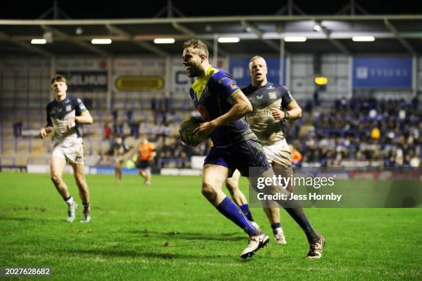 James Harrison of Warrington Wolves runs in to score his team's fifth try during the Betfred Super League match between Warrington Wolves and Hull FC...