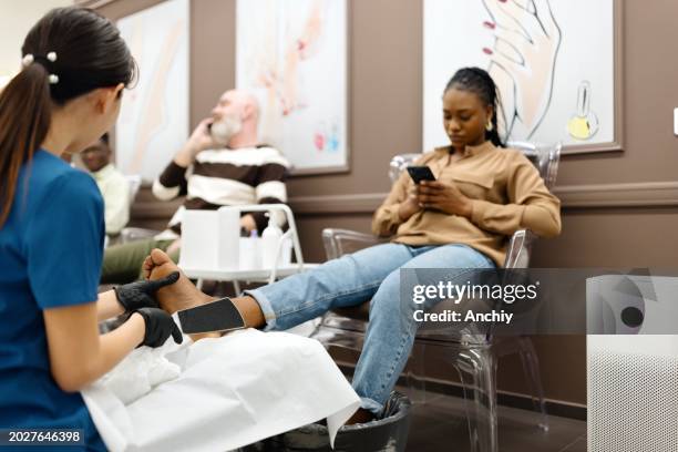 a carefree woman doing her pedicure - manicure set stock pictures, royalty-free photos & images