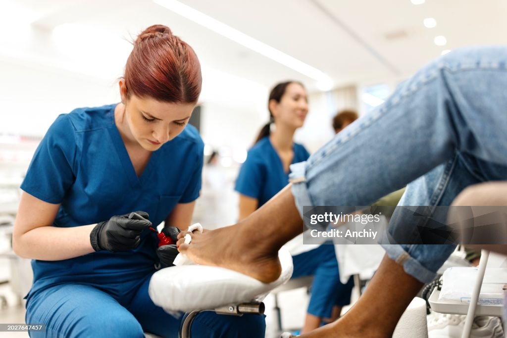 Woman doing her pedicure in a beauty salon