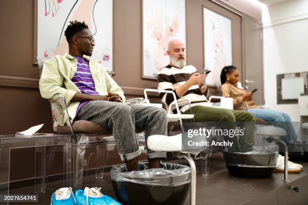 modern people doing pedicure - black painted toes stock pictures, royalty-free photos & images