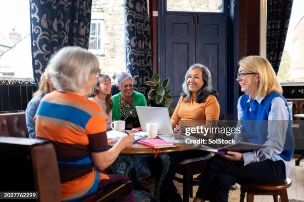 women bonding over coffee and work - persian restaurant stock pictures, royalty-free photos & images