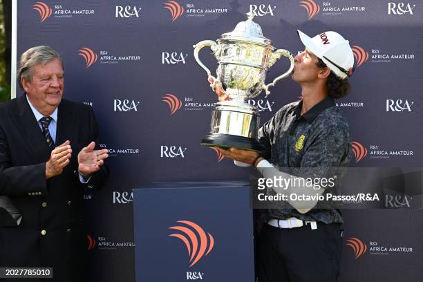 Altin Van Der Merwe of South Africa kisses the trophy watched by Johann Rupert following his victory in a playoff during day four of the Africa...