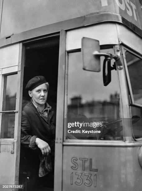 Bus driver Dolores Rennie sitting by the bus driver's' seat in a double deck bus, London, UK, 4th April 1944. She is the first woman bus driver in...