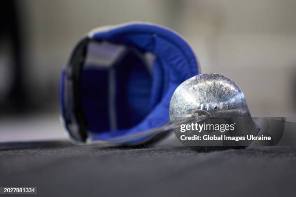 Fencing mask and a saber are seen during the men’s saber fencing tournament as part of the All-Ukrainian Competition of the Strongest of Ukraine on...