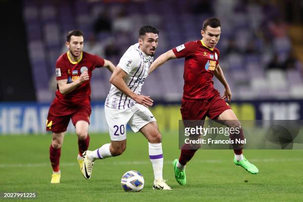 Matias Palacios of Al Ain runs with the ball whilst under pressure from Akmal Mozgovoy of FC Nasaf during the second leg of the AFC Champions Leauge...