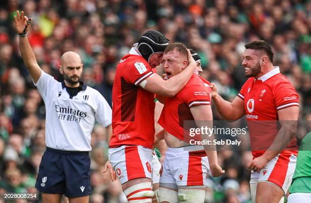 Dublin , Ireland - 24 February 2024; Tommy Reffell of Wales, second from right, celebrates with teammate Adam Beard after winning a turnover penalty...