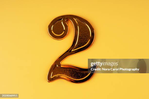 number 2 on yellow background - 2nd anniversary fotografías e imágenes de stock