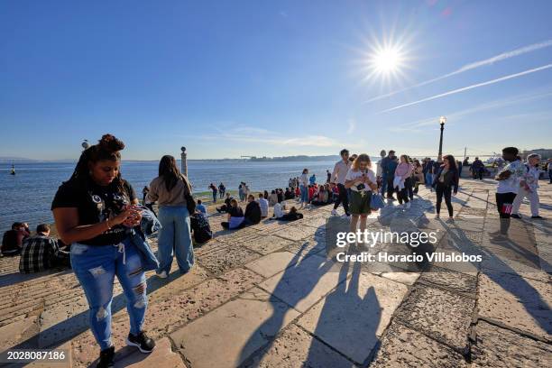 Visitors crowd Cais das Colunas in Terreiro do Paço by the Tagus River, a favorite tourist spot, on February 19 in Lisbon, Portugal. Tourism...