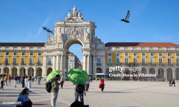 Free Tours operators wait for customers in Praça do Comercio, a favorite tourist spot, at the end of the afternoon on February 19 in Lisbon,...