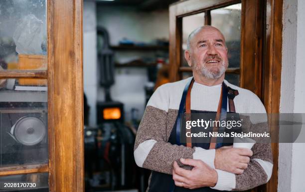 portrait of a senior man in hi workshop - grey belt stock pictures, royalty-free photos & images