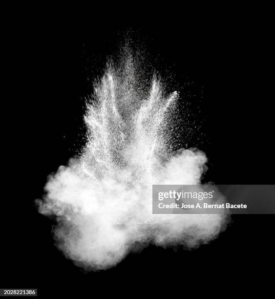 multiple explosions of smoke and dust in expansive motion on a black background. - detonator stock pictures, royalty-free photos & images