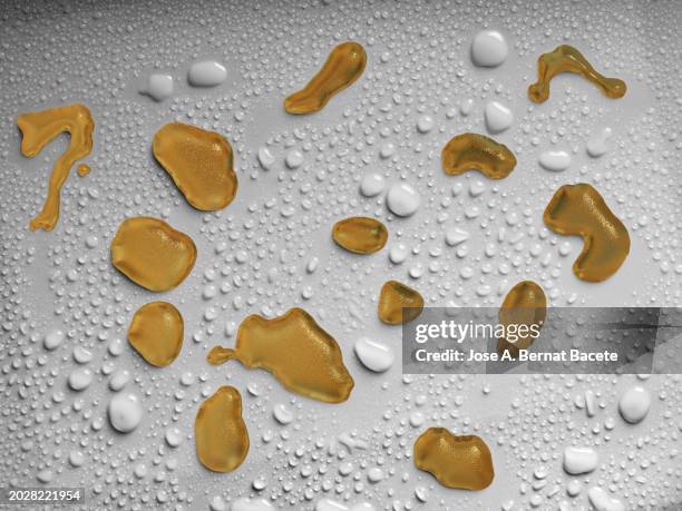 drops of liquid honey slide over a  gray surface with small drops of water. - bee stock illustrations stock pictures, royalty-free photos & images