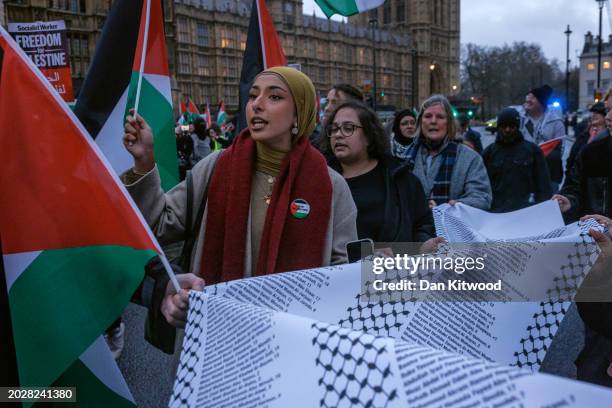 People carry a list of names of children killed in Gaza during a rally calling for a ceasefire, outside parliament as MPs consider a motion on Gaza...