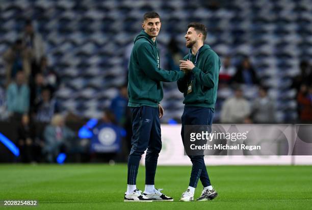 Kai Havertz interacts with Jorginho of Arsenal as they inspect the pitch prior to the UEFA Champions League 2023/24 round of 16 first leg match...