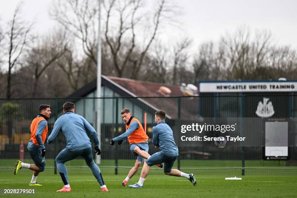 Harvey Barnes strikes the ball as Paul Dummett Second from left) and Kieran Trippier defend during the Newcastle United Training Session at the...