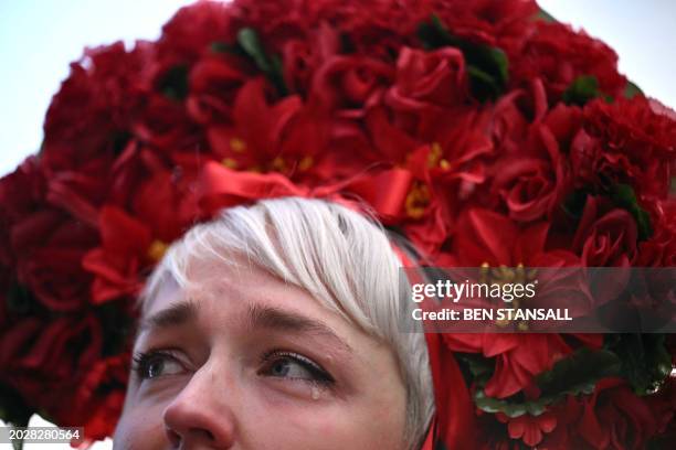 Woman wearing traditional Ukrainian dress, sheds a tear at a vigil in Trafalgar Square, in London on February 24 to mark 2 years since the beginning...