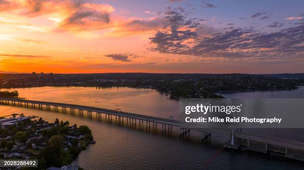 aerial 520 floating bridge sunset lake washington - lake washington stock pictures, royalty-free photos & images